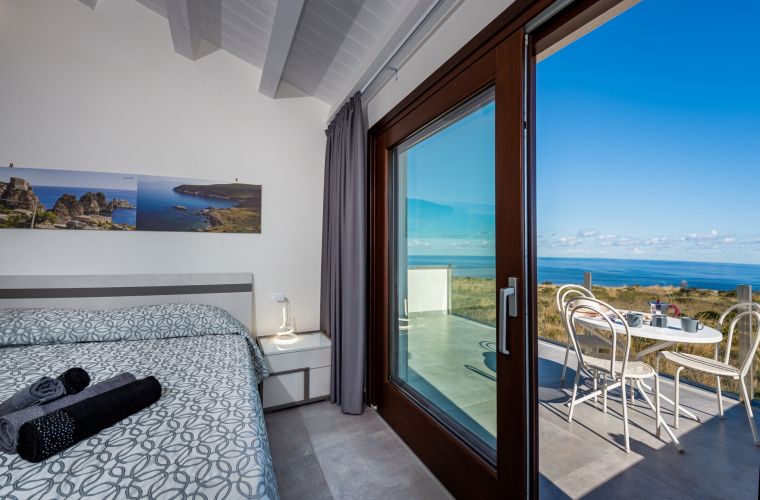 A comfortable internal staircase leads to the upper floor, where there are three double bedrooms, one of which has a balcony with sea view and a private bathroom with shower.