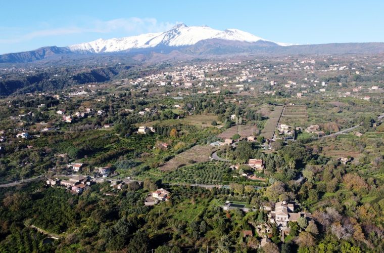 The villa and Etna volcano on the background