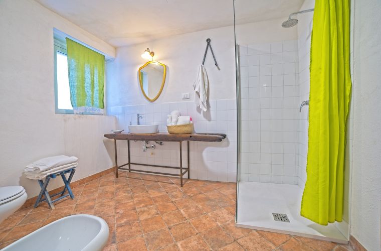 A bathroom with a shower on the first floor