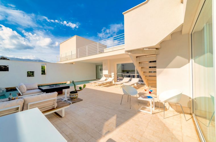 The beautiful exterior features several relaxing corners and a BBQ area.