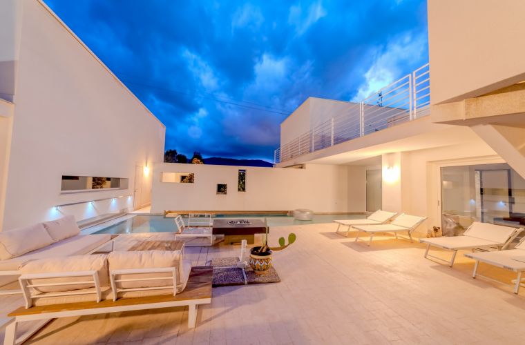The beautiful exterior features several relaxing corners and a BBQ area.