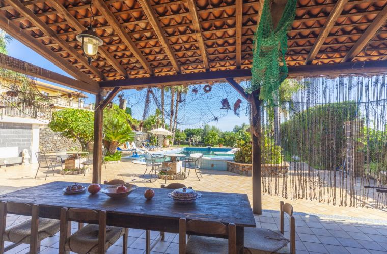 Patio with BBQ facing the pool