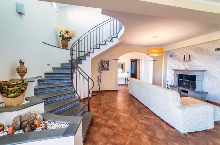 An elegant staircase leads to the upper floor where we have another bedroom en-suite and a cozy living that leads to a panoramic terrace, furnished with lounge and BBQ corner.