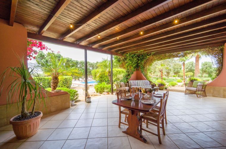 Just facing the ground floor there is a spacious patio with lounge, sofas, BBQ, and a dining table.