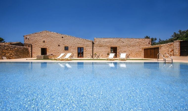 Pool and facade in typical Sicilian stone