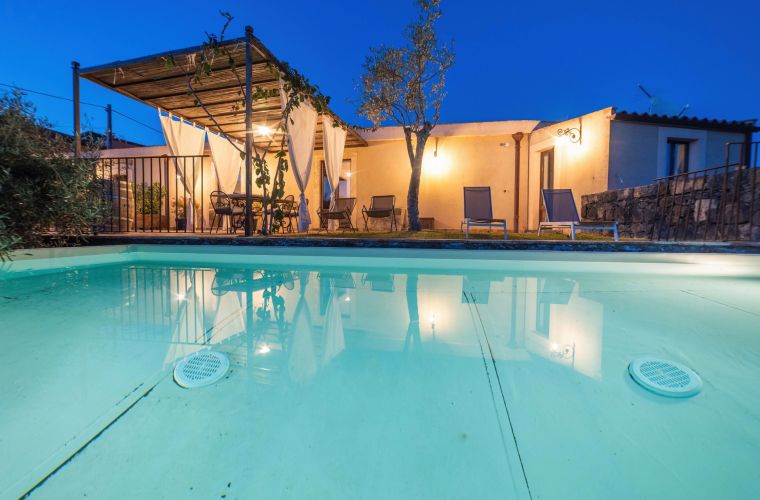 The exterior features a large solarium with a gazebo and BBQ area
