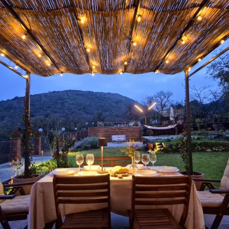 Patio outside the kitchen, facing the pool and the little conic shape of Serra