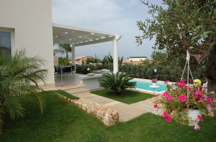 The villa is designed in a Mediterranean style; it extends over two levels