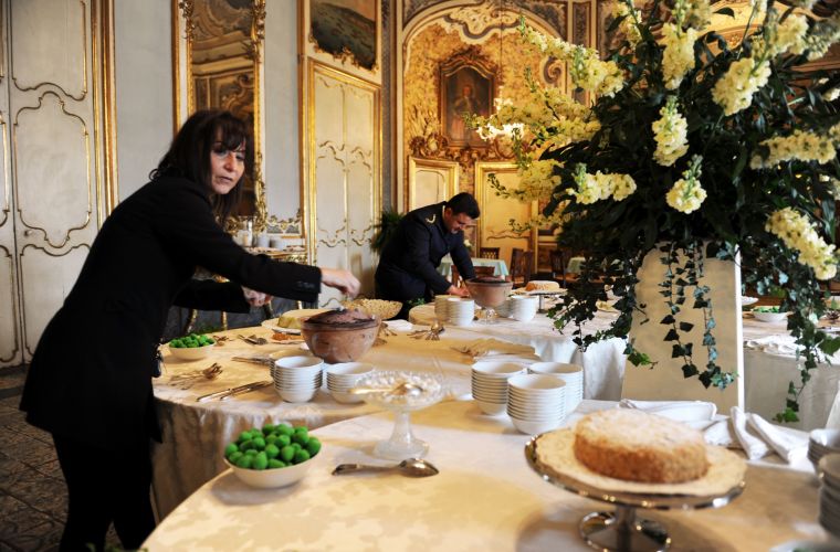 Silvana is arranging the table of the sweets for a very important meal of Russian customers